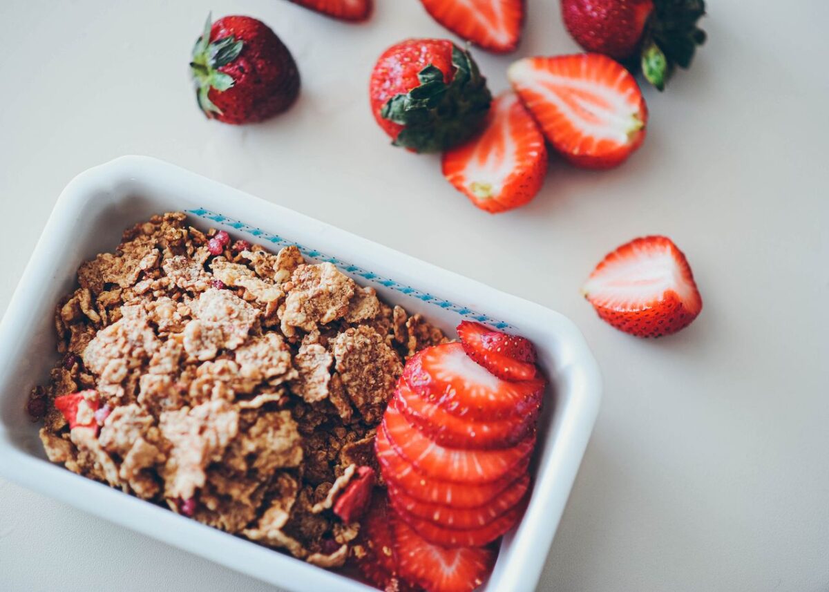 Close-up view of strawberries and cereal for a nutritious breakfast option.